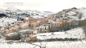 巴尔德利纳雷斯Apartamento Valdelinares,Casa la roca的山中积雪覆盖的城镇