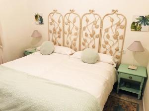 赫雷斯-德拉弗龙特拉Casa Buleria的卧室配有白色的床和2个枕头