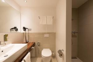 汉堡城市公园酒店的浴室配有白色卫生间和盥洗盆。