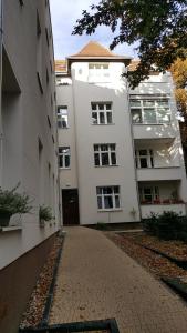 波兹南Apartament w Starej Kamienicy的白色建筑前的一条空的街道