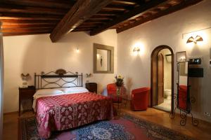 佛罗伦萨科洛迪佛罗伦萨酒店的一间卧室配有一张红色床罩的床