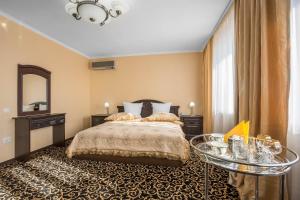 利佩茨克利佩茨克酒店的一间卧室配有一张床、一张桌子和一面镜子