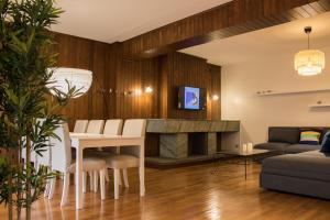 加亚新城Origami Porto Residência & Hostel的客厅配有桌子和壁炉