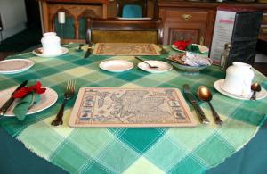 奈恩Greenlawns的一张桌子,上面有蓝色的绿桌布,上面有银器