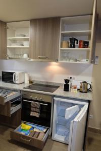 圣胡安-德拉斯阿巴德萨斯Apartaments Sant Miquel的厨房配有开放式冰箱和炉灶。