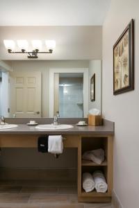 萨拉索塔Carlisle Inn Sarasota的一间带两个盥洗盆和大镜子的浴室