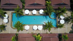 拉威海滩勒比曼度假酒店的享有带白色遮阳伞的游泳池的顶部景致