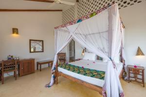 南威瓦雷雷海滩酒店的一间卧室配有一张带天蓬的床