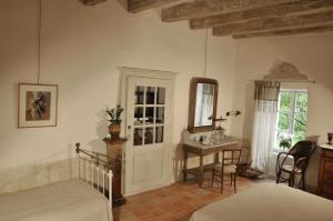 Penne-dʼAgenaisLe Relais de Roquefereau的一间卧室配有一张床、一张书桌和一面镜子