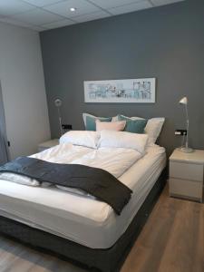 胡萨维克波斯特广场宾馆的卧室配有白色大床和蓝色的墙壁