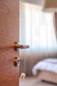 普里什蒂纳Boulevard Prishtina的一个带钥匙的门,位于带一张床的房间