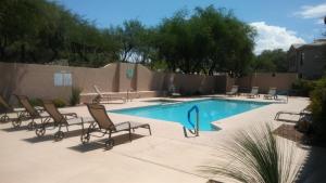 土桑Casitas at Sabino Springs的一个带躺椅的游泳池和一个游泳池