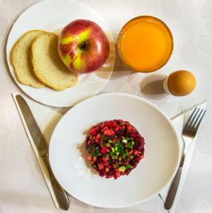 亚列姆切Villa Iris的一张桌子,上面放着两盘食物,一个苹果和烤面包