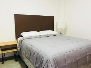 SuchitotoCasa Hotel Santa Lucia的一间卧室配有一张大床和床头柜