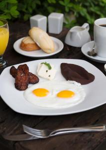 危地马拉安地瓜安提瓜古阿特马拉奥利沃斯精品酒店的桌上的一盘鸡蛋和其他食物