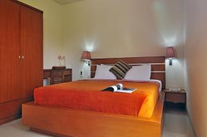 塔曼阿玉联排别墅酒店客房内的一张或多张床位