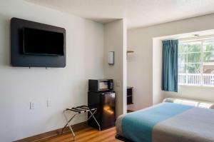莫比尔提尔曼斯角莫比尔提曼斯角伊克诺旅馆的酒店客房设有一张床和墙上的电视