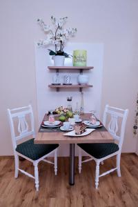 巴特科尔格鲁布Hörnlestubn的一张桌子,上面有一盘食物,上面有两把椅子