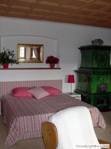 玛利亚采尔Villa Tadina Ferienwohnungen Mariazell的卧室配有一张床,墙上设有镜子