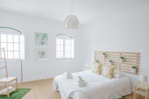 奥良Casas de Mar - Casa Âncora的白色卧室配有床和椅子