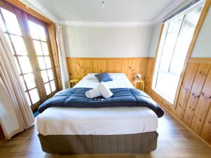 Lake TabourieIngenia Holidays Wairo Beach的一间卧室配有一张带蓝白色床单的大床