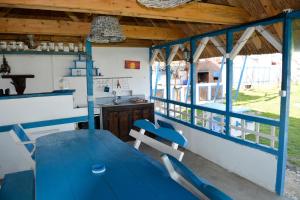 茹里洛夫卡Sailors Guest House Jurilovca的一间配备有蓝色桌子和椅子的用餐室