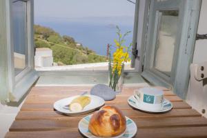 EmporeiósPyrgos Stone House的餐桌,盘子上放着面包和咖啡