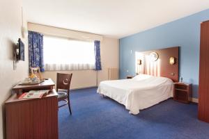 勒阿弗尔勒阿弗尔波彭斯莱斯让德马尔酒店的酒店客房配有一张床、一张桌子和一把椅子。