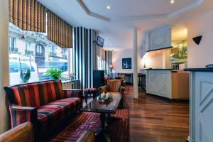 巴黎杜普雷酒店的客厅配有沙发和桌子
