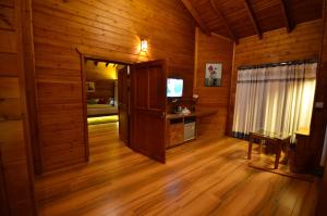 安巴拉瓦亚尔LakeRose Wayanad Resort的客厅设有木墙和木地板