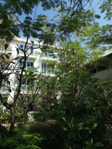 班佩罗勇府玛迈别墅酒店的前面有树木的白色建筑