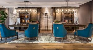 夏洛特艾维酒店的一间配备有蓝色椅子和桌子的用餐室