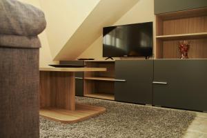奥亚Casa Toñi的客厅配有电视和带桌子的橱柜。