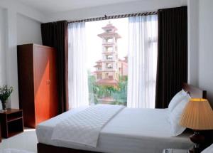 宁平Sunflower Hotel的一间卧室设有一张床,窗户与大楼相连