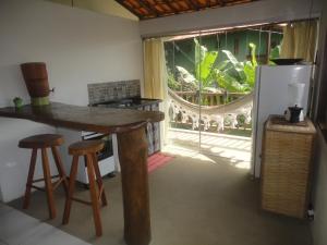 伊塔卡雷Flat Pituba Itacaré的厨房配有桌子、凳子和窗户