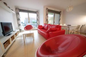 安波拉Casa Joana的客厅配有红色沙发和电视