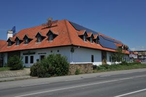 Tvarožná洛恒卡奥斯特利兹汽车旅馆的路旁有橙色屋顶的建筑