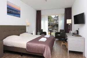 斯希蒙尼克奥赫山丘景观咖啡餐厅酒店的酒店客房,配有一张床、一张桌子和椅子
