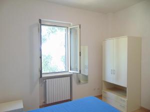 维耶斯泰Appartamento in villa con giardino Pizzomunno的一间卧室设有一张床和一个窗口