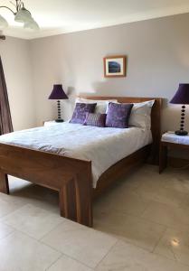 格伦蒂斯Park View的一间卧室配有一张带紫色枕头的大床