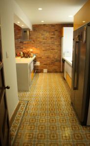 波哥大Magdalena Guest House的厨房铺有瓷砖地板,配有冰箱。