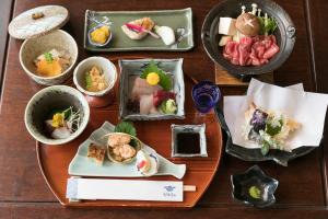 高山寿美吉旅馆的一张桌子,上面放着几盘食物