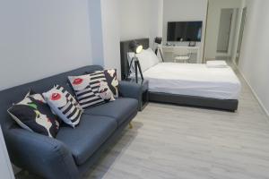 新加坡Comfy Studio 5 by ReCharge的客厅配有沙发和1张床