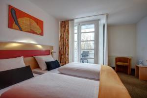纽伦堡纽伦堡中心酒店的酒店客房设有两张床和窗户。