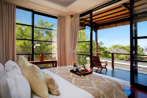 金巴兰寺山别墅酒店的一间卧室设有一张大床和大窗户
