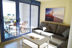 坎布里尔斯Golive Esquirol Beach的客厅配有沙发和桌子