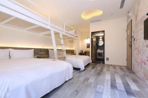 台中市MINI HOTELS (台中火车站馆)的酒店客房设有两张床和梯子