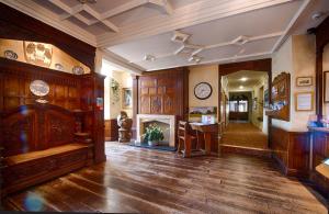 翰索Miskin Manor Hotel的大型客房设有木镶板和壁炉。