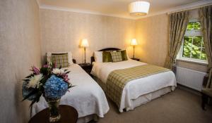 韦克斯福德吉利安城堡乡间别墅农场酒店的酒店客房带两张床和花瓶