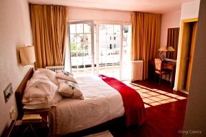 塔雷加平托尔马尔萨酒店的酒店客房设有一张床和一个阳台。